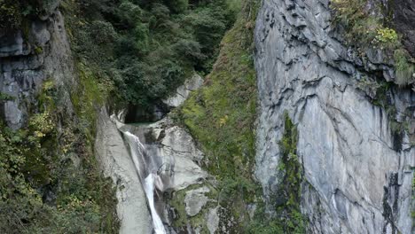 Waterfall-cascading-over-Mount-Cangshan-mountainside,-China,-aerial-view