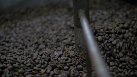 coffee-beans-spinning-in-roaster,-close-up-slow-motion
