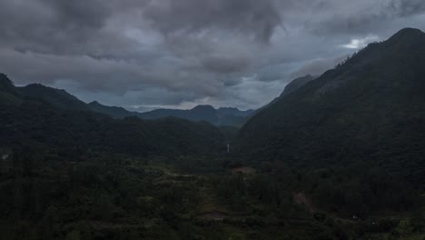 Drone-aerial-hyperlapse-during-sunset-of-a-beautiful-landscape-view-with-mountains,-cloud-weather-and-a-river-in-Guatemala,-central-america