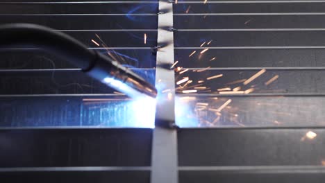 Close-up-work-with-metal-steel-and-iron-using-a-welding-machine