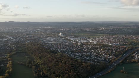 Drone-Aerial-Shot-the-german-freeway-A7-crossing-the-center-of-Kassel-at-sunset-in-Germany,-Hessen,-Europe