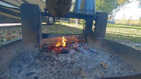 Laying-wood-on-hot-coals-and-wood-catches-fire