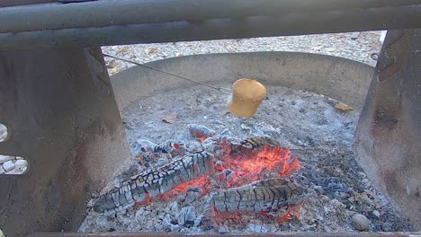 Large-roasted-marshmallow-browning-over-a-campfire
