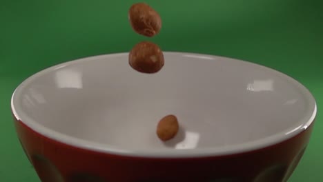 Front-view-of-Japanese-peanuts-falling-on-a-plate