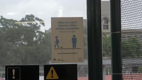 Soziales-Distanzierungszeichen-Auf-Glasfenster---Redfern-Bahnhof---Sydney,-Nsw,-Australien