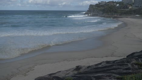 Ocean-Waves-Washing-Up-On-The-Sandy-Shore-Of-Bronte-Beach---Coastal-Walk---Coronavirus---Sydney,-NSW,-Australia