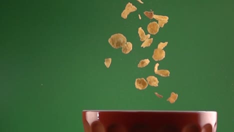 Corn-flakes-falling-on-a-plate-on-a-chroma-background