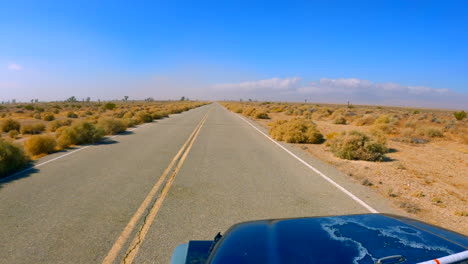 Driving-along-a-road-going-through-the-Mojave-Desert-landscape-in-Southern-California