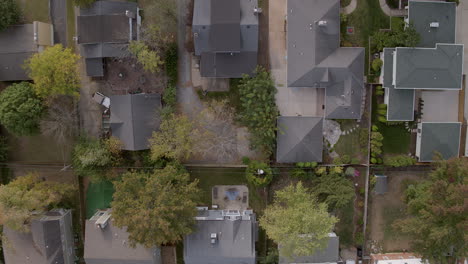 Overhead-view-of-suburban-houses-and-trees-with-descent-downward