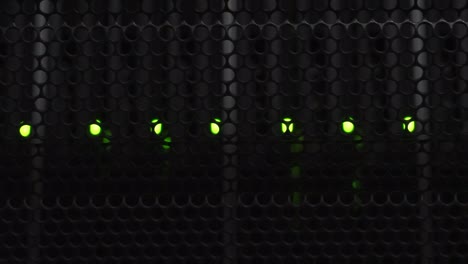 Vertical-video-of-flashlight-shining-in-dark-server-room-over-data-storage-with-flashing-green-led-lights