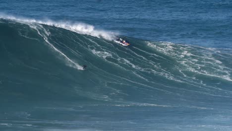 Slow-motion-of-a-big-wave-surfer-Kai-Lenny-riding-a-monster-wave-in-Nazaré,-Portugal