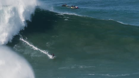 Slow-motion-of-a-big-wave-surfer-Caio-from-Brazil-riding-a-monster-wave-in-Nazaré,-Portugal