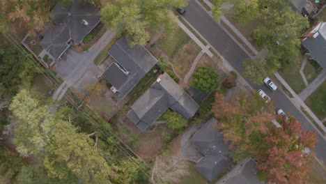 Overhead-aerial-view-of-suburban-houses-and-neighborhood-street-with-a-spin-as-a-car-drives-through