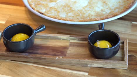 Korean-Pizza-With-Egg-Yolks-On-The-Side-Served-In-A-Restaurant-In-Chuncheon-si,-South-Korea---close-up