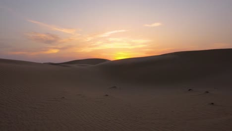 Walking-over-incredible-Abu-Dhabi-Sand-Dunes-during-a-Magnificent-Orange-Sunset