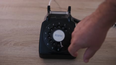 Dialing-a-phone-number-on-an-antique-rotary-dial-phone