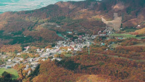 Fall-Season-In-Yamagata-City---Zao-Onsen-Surrounded-By-Colorful-Mountain-Forest-In-Japan---aerial