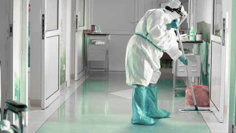 Cleaning-the-hospital-floor-in-full-protective-clothing,-difficult-working-conditions-during-an-epidemic