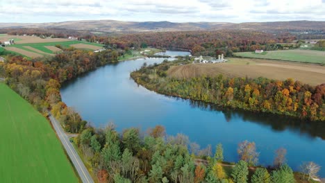 Aerial-of-rolling-hills-in-Lancaster-County-PA,-Speedwell-Forge-Lake-surrounded-by-rural-farmland