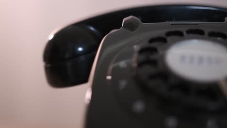Close-up-rotating-product-shot-of-a-retro-style-black-rotary-dial-phone