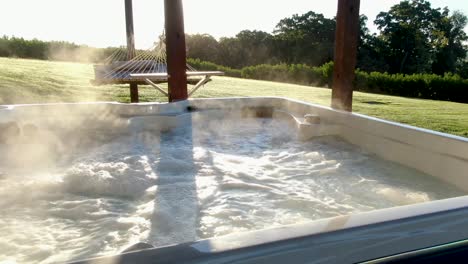 Steaming-sauna-hot-tub-pool-bubbles-during-morning-sunrise