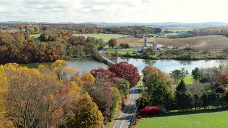 Aerial-establishing-shot-of-road-and-bridge-over-lake-in-Lancaster-County,-PA-USA