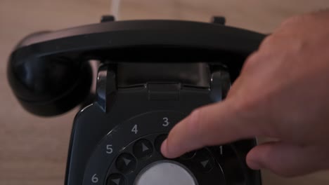 Close-up-of-dialing-numbers-on-a-vintage-rotary-dial-phone