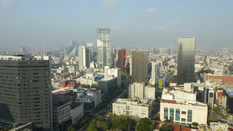 Modern-Buildings-in-Mexico-City's-Centro-Historic-District,-Monument-to-the-Revolution-in-Background