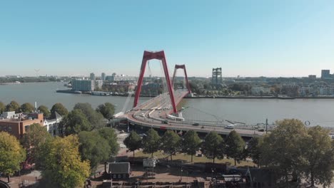 Aerial-footage-of-the-Willemsbrug-Bridge-spanning-across-a-water-channel-in-Rotterdam,-Netherlands