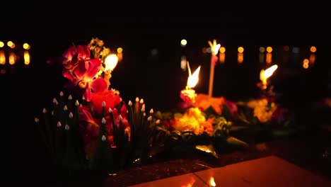 Loy-Krathong-Festival:-Close-up-shot-of-Colorful-Krathongs-with-a-burning-candles-and-incense-on-top