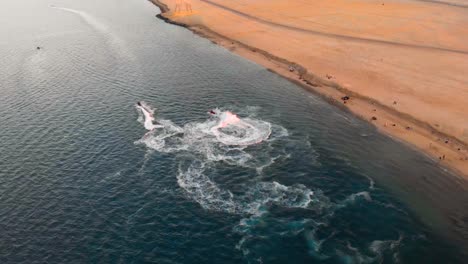 Jet-Skis-Spin-and-do-Donuts-in-Tropical-Ocean-Waters-by-a-Barren-Abu-Dhabi-Coastline