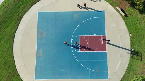Aerial-view-of-two-guys-competing-in-a-game-of-one-on-one-basketball