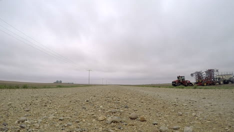 Farm-Tractor-And-Seeding-Equipment-After-Work-At-The-Field---ground-level-GoPro-shot