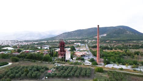 Aerial-drone-4k-clip-turning-close-to-a-factory-chimney-and-an-industrial-area-in-the-area-of-Drama-in-Northern-Greece