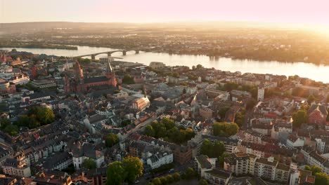 Drohne-over-Mainz-in-a-perfect-wide-shot-showing-the-Dome-and-the-city-center-with-the-Rhine-River-in-the-background-in-perfect-sunny-summer-light-on-a-early-morning-in-Germany-by-a-cine-drone