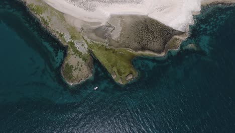 Boat-sailing-by-the-beautiful-shoreline-of-the-Patagonian-Sea--Aerial