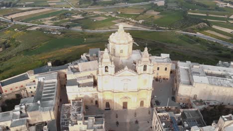 High-aerial-4k-drone-footage-circling-the-Roman-Catholic-Parish-Church-of-Sacro-Cuor-in-Sliema,-Malta,-a-densely-populated-town-on-an-island-of-the-Mediterranean-Sea