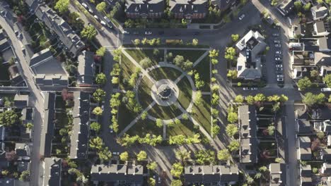 3-3-aerial-birds-eye-view-hold-over-town-square-park-gazebo-during-morning-rush-hour-as-students-head-out-for-school-and-employed-people-head-out-to-work-during-ignored-pandemic-lockdown-in-Calgary-AB