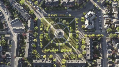 2-3-aerial-birds-eye-view-drop-over-town-square-park-gazebo-during-morning-rush-hour-as-students-head-out-for-school-and-employed-people-head-out-to-work-during-ignored-pandemic-lockdown-in-Calgary-AB