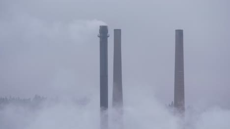 Paper-Mill-Factory-chimneys-emitting-a-smokestack-into-the-atmosphere-on-a-Cold-Overcast-day---Close-up-long-shot