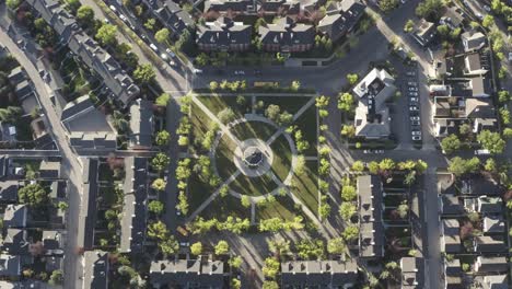 1-3-aerial-birds-eye-view-drop-over-town-square-park-gazebo-during-morning-rush-hour-as-students-head-out-for-school-and-employed-people-head-out-to-work-during-ignored-pandemic-lockdown-in-Calgary-AB