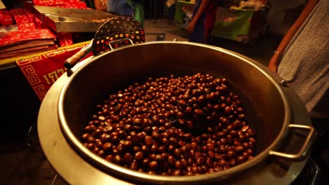 4k-Brown-Chestnuts-cooking-in-a-spinning-street-food-roaster-machine