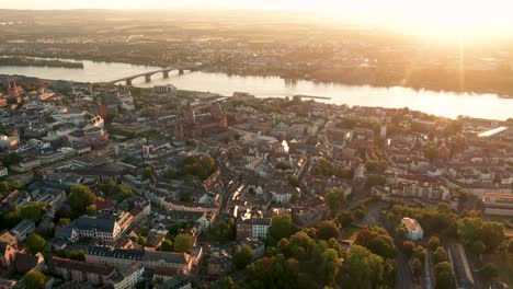 Rising-up-drone-shot-of-Mainz-by-a-cine-drohne-with-lensflares-on-a-sunny-summer-morning-in-Germany