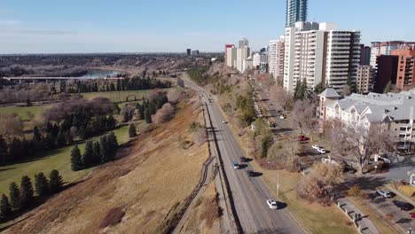 aerial-fly-over-drop-by-rivers-edge-vip-golf-course-park-in-the-fall-edged-with-high-rise-condomiums-apartments-and-commercial-building-by-roadside-access-to-the-freeway-highway-groat-bridge-park-3-3