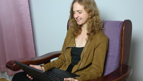 Portrait-of-young-female-having-online-conversation-on-laptop