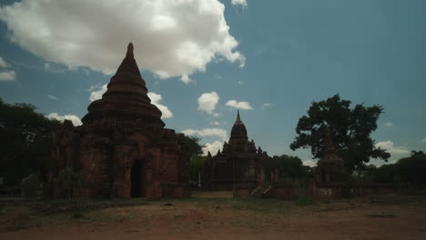 Historical-ruins-of-temples-in-Bagan,-Myanmar-taken-during-the-midday-with-fast-moving-clouds-and-no-people