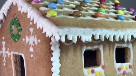 Reveal-of-a-ginger-bread-house-made-with-honey-and-flour-with-Christmas-decorations-with-candies-and-white-snow-like-decoration