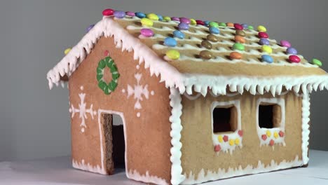 Reveal-of-a-ginger-bread-house-made-with-honey-and-flour-with-Christmas-decorations-with-candies-and-white-snow-like-decoration