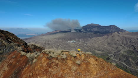 Wide-revealing-drone-shot-of-mountain-range-near-the-volcano-Mount-Aso