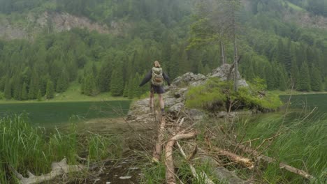 Sport-holiday-maker-woman-go-hiking-near-a-green-lake